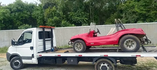 Buggy vermelho transportado em plataforma